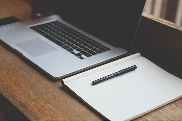 laptop, notebook, and pen