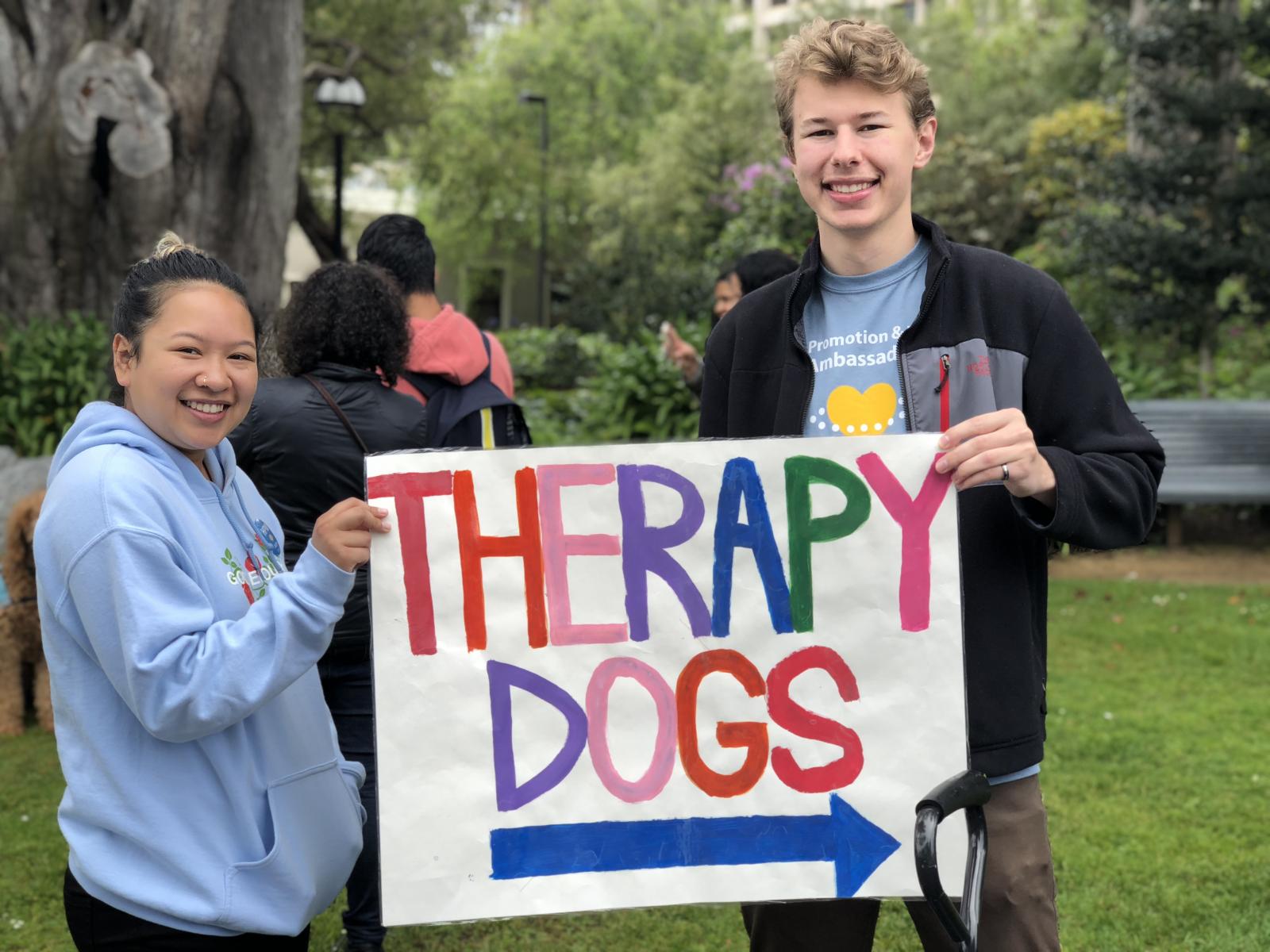 Two Students Holding a Therapy Dogs Poster